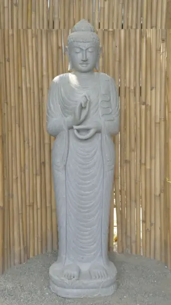 Product image of the product “Standing Buddha made of Riverstone in Dharmachakra position - gesture of wheel of the teaching of Dharma. About 181cm height. ”
