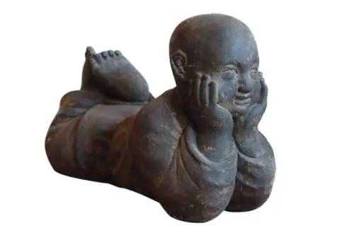 Product image of the product “Lying monk, 43 cm width, cast stone, hollow, handcrafted & coloured 40 cm (hollow)”