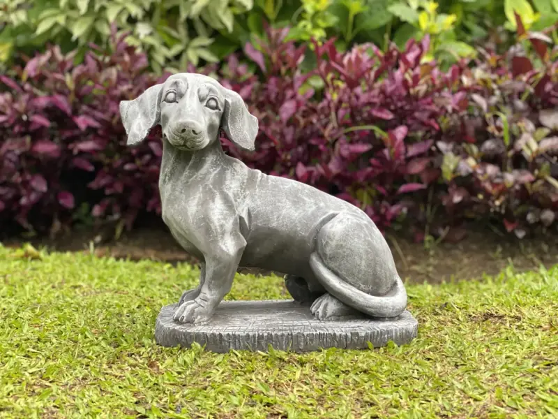 Product image of the product “Timber - Dachshund sitting on a pedestal, 37 cm L | cast stone ”